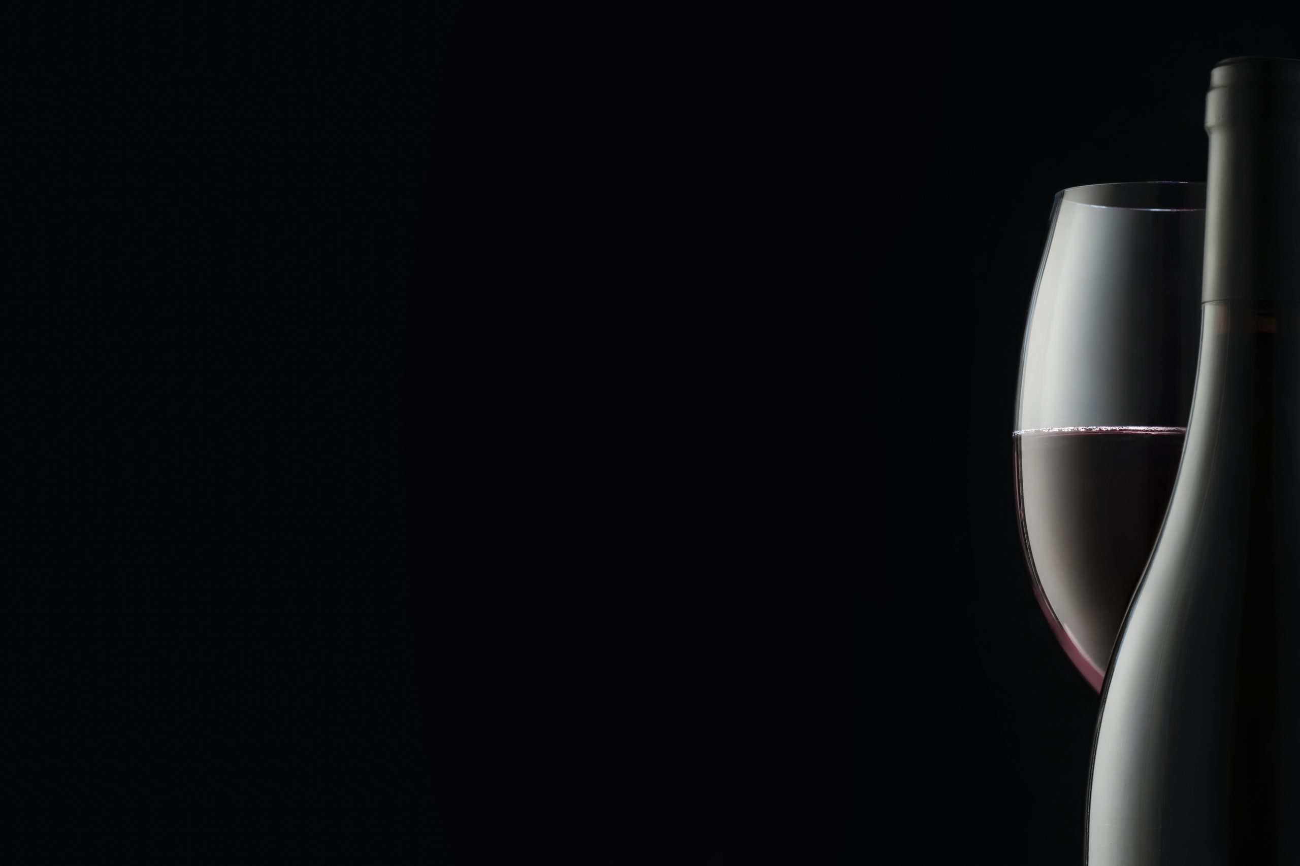 the outline of an elegant wine bottle and a glass of red wine. concept for a restaurant or wine boutique, copy space